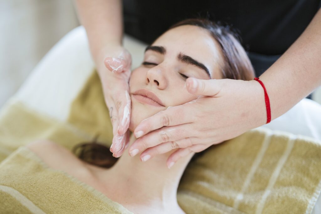 Young woman receiving facial beauty treatment at CC's spa in West Des Moines